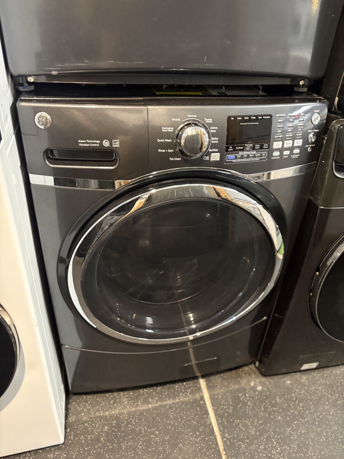 GE charcoal black front-load washer, front view
