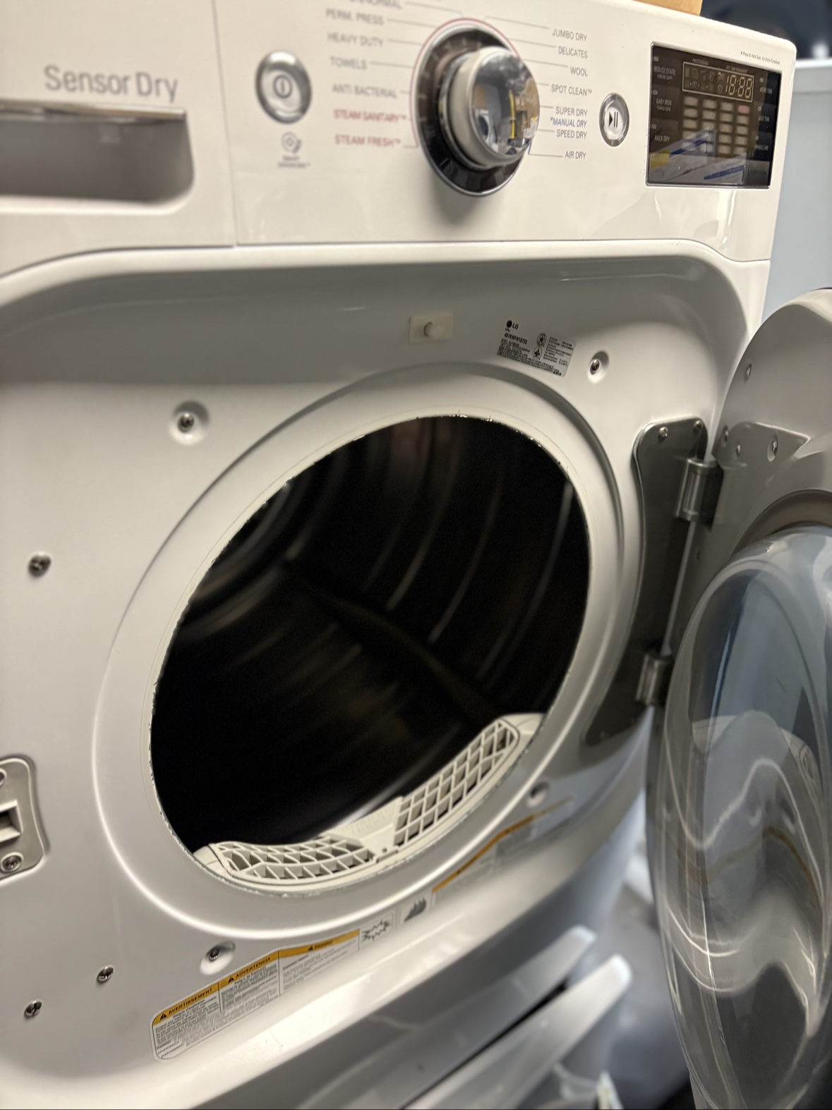 LG Mega gas dryer with its door open, showing the drum and Sensor Dry controls