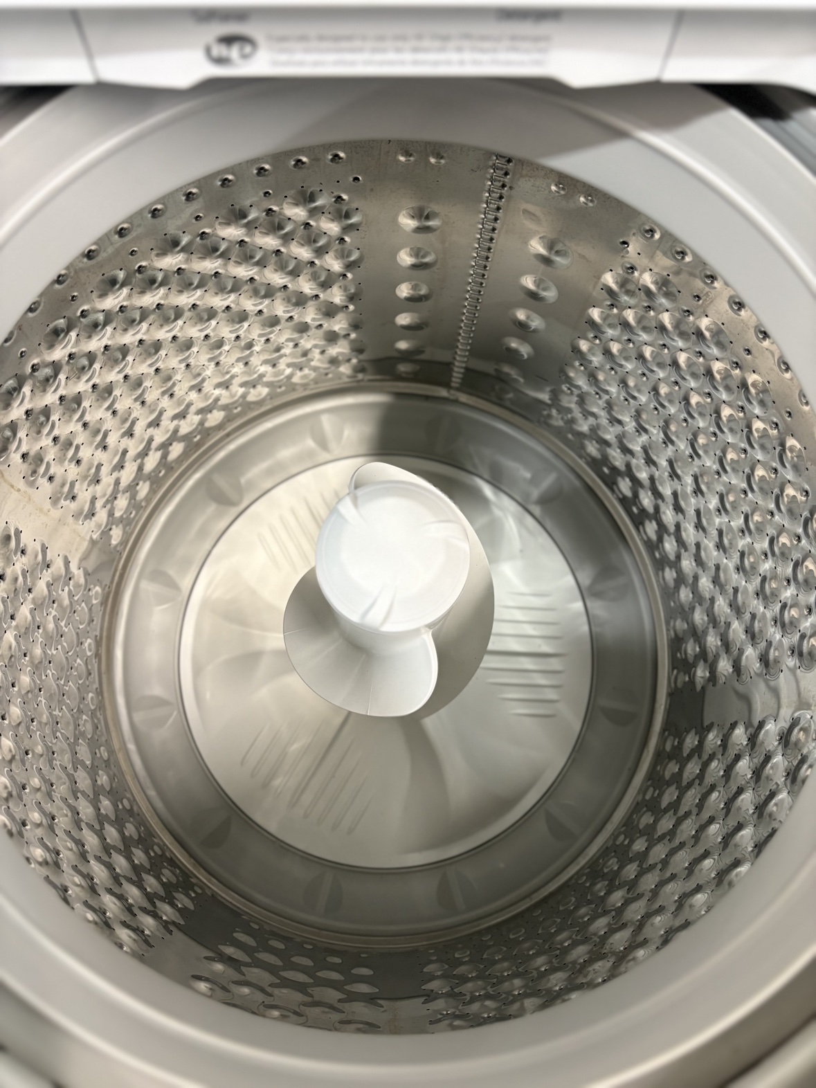 Inside the stainless steel LG top-load washer tub