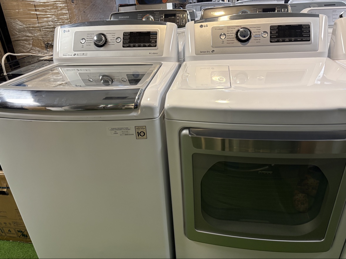 White LG Direct Drive top-load washer and matching dryer together on the appliance floor