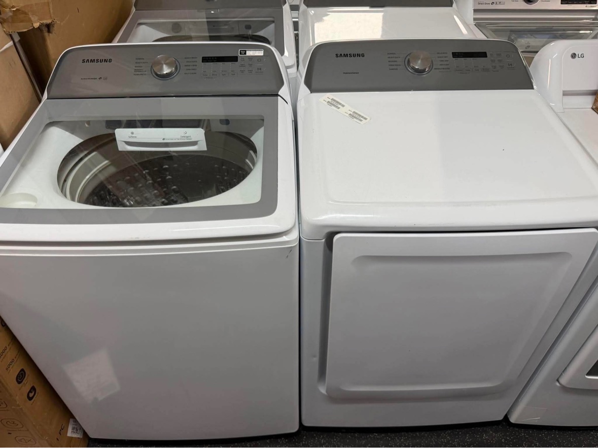 White Samsung top-load washer and dryer pair in the store