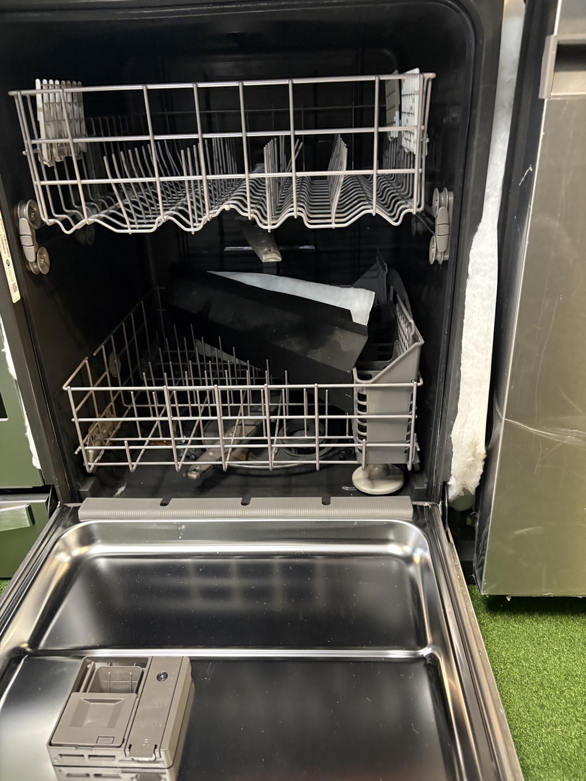 Whirlpool dishwasher open, showing the racks inside